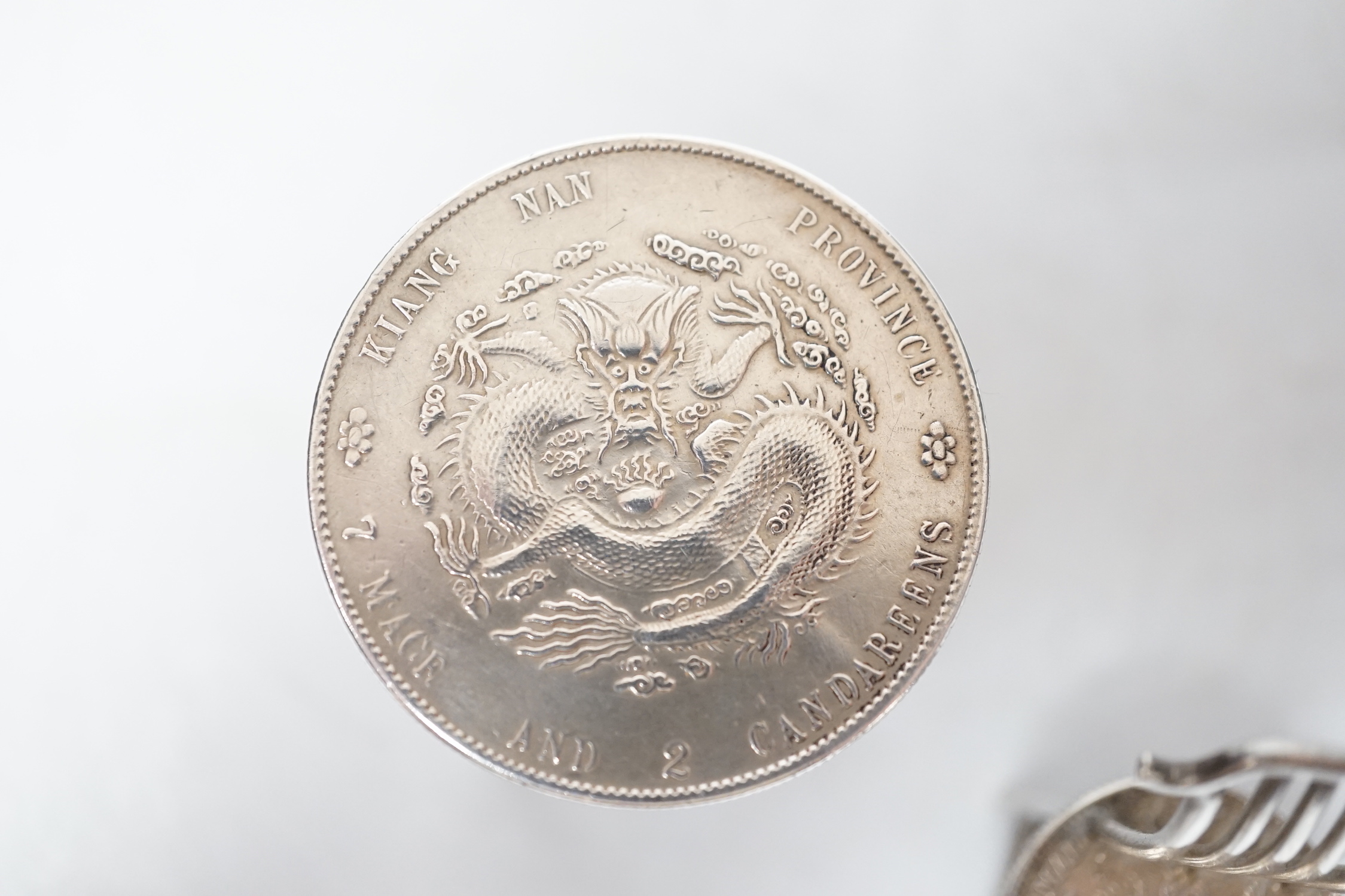 A Chinese Republic period one dollar 1920, and two Chinese Guangxu period coins mounted as miniature furniture, table 4vm higher